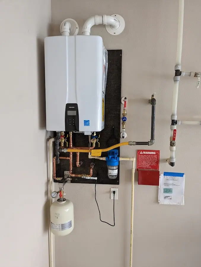 Professional plumber installing copper piping in a Santa Rita Ranch home